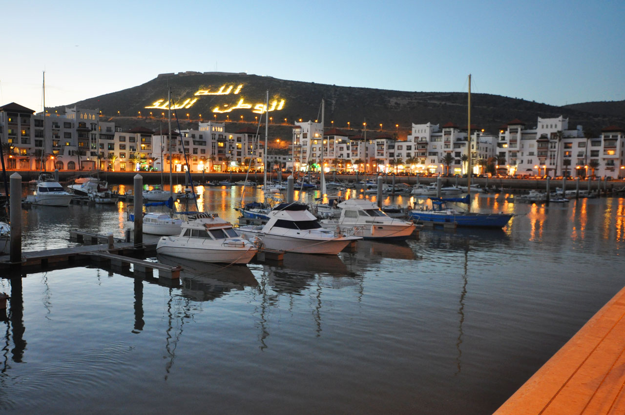 Agadir Marina, views of the illuminated mountain. The words read, 'God, King & Country'