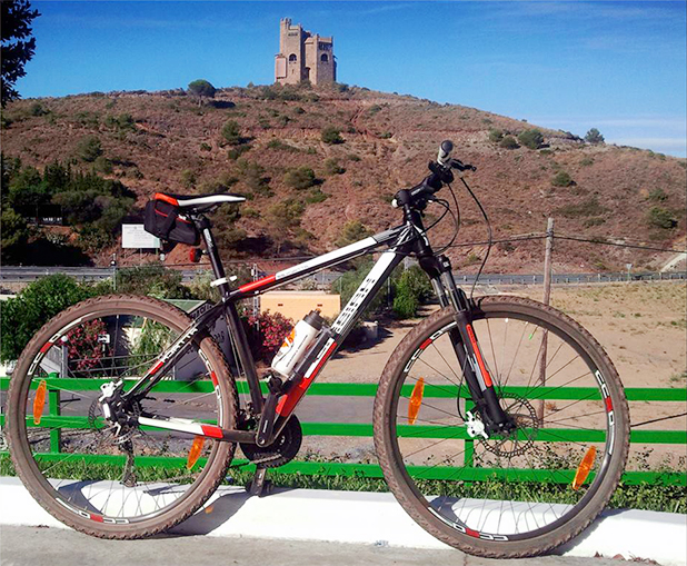 Mijas Wheels - a great way to see the sites and keep fit, pictured in the background is Torres de Fahala fortress. Image courtesy of Mijas Wheels