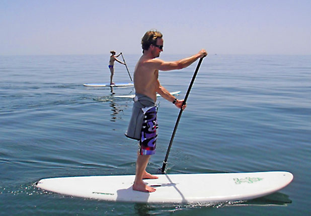 Stand Up Paddle has a larger than average surf board and a long paddle to steer and propel you - photo courtesy of www.standuppaddlemarbella.com