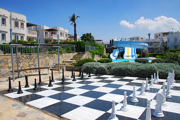 Giant chess with seating area and the waterslides can be seen further back